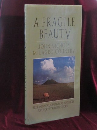 Item #08532 A FRAGILE BEAUTY. John Nichols' Milagro County. John Nichols, Robert Redford, SIGNED